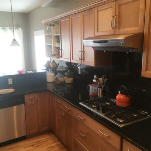 Maple kitchen cabinets refinished in a mellow tone stain.